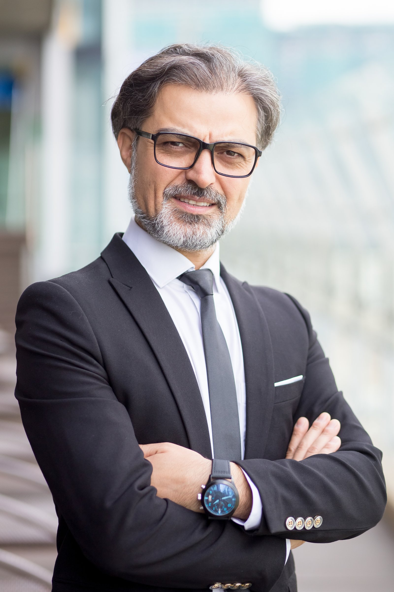 James Anderson, wearing a dark suit and glasses